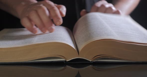 The Man Turns the Pages of the Textbook alt