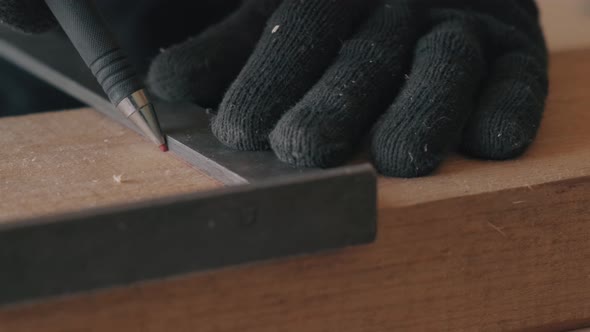 Hands in Black Gloves Holding the Corner Tool and Drawing with a Pencil