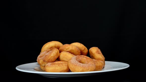 Donuts in Plate Being Picked Up