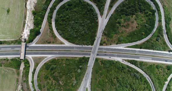4K aerial footage of highway intersection. Road junction with traffic. Top view alt