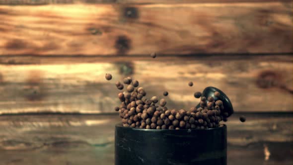 Super Slow Motion in a Mortar with Black Pepper Peas Falls Pestle alt