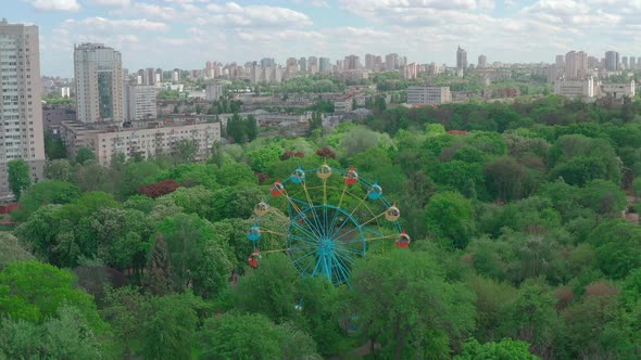 Beautiful Ferris Wheel in the Green Area of the City Park