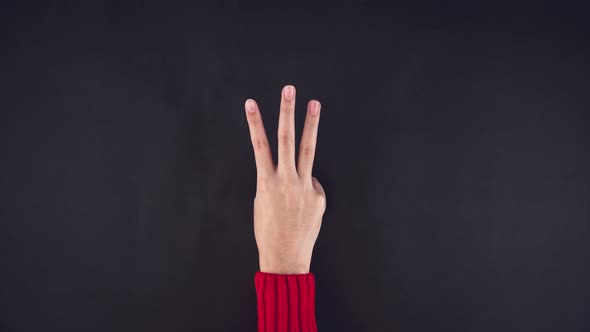 Hand of the girl counting number with fingers from five to zero
