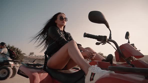 Cute Brunette with European Looks Denim Shorts Sitting on a Quad Bike in Cappadocia alt