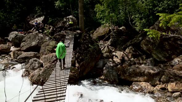 Hiker Person Crawling Walking on Rope Bridge Iroi alt