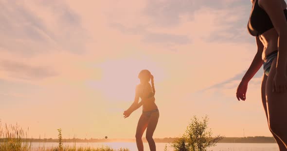 Group of Young Girls Playing Beach Volleyball During Sunset or Sunrise, Slow Motion, alt