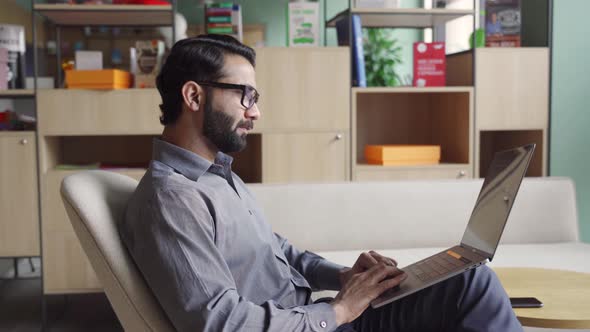 Indian Business Man Trader Investor Analyst Looking at Financial Market Charts alt