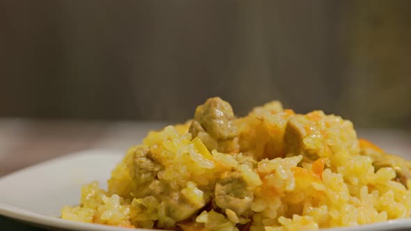 Dish of Hot Pilaf Pilau Pilaw or Pilaff with Turkey Meat Spinning on Plate alt