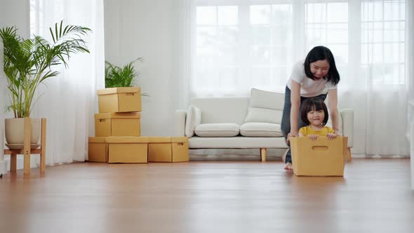 asian family playing with a box.Together having fun inside the house.family relationship