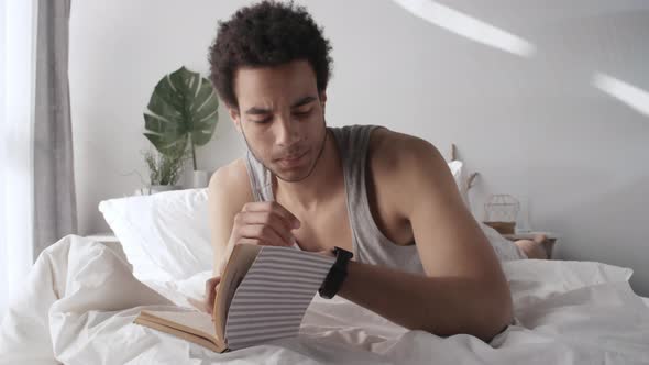 Man Reading Book after Waking Up alt