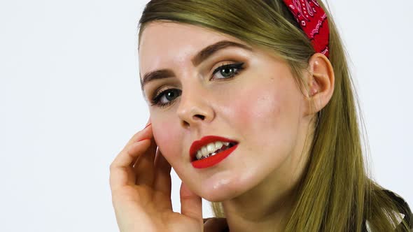 A Beautiful 50s Pin up Girl Poses Seductively for Camera, Face Closeup, White Screen Background alt