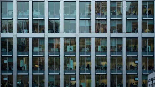 Day to night timelapse of the exterior of an office block at night