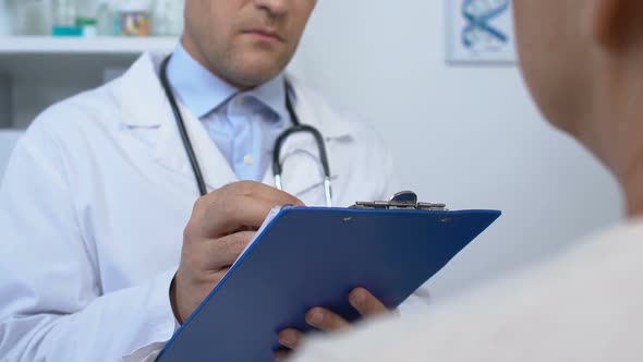 Serious Doctor Filling Patient Data in Medical Record, Bad Diagnosis, Health