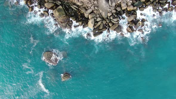 Aerial view sea waves texture breaking stones