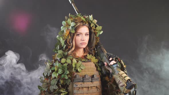Woman Soldier Sniper in Disguise with Sniper Rifle and Aims in Smoky Darkness alt