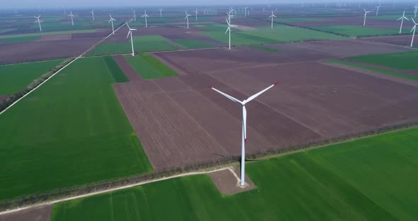 4K aerial drone view of a wind turbine. Windmill for electric power production. Green energy.  alt