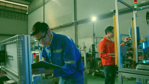 smart asian technical engineer working with assemble involved in the machine working design process alt