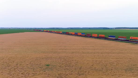 Transportation industry: train in motion on countryside, 4K UHD drone aerail footage.