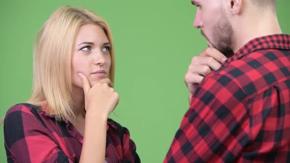 Young Couple Thinking While Looking at Each Other