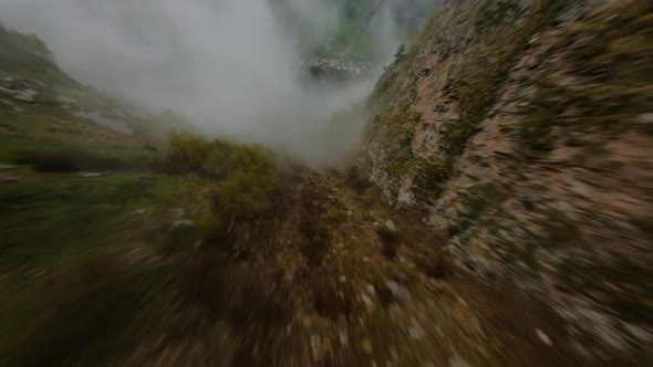 Fpv Drone Shot Diving Mountain Gorge Through the Clouds at High Speed