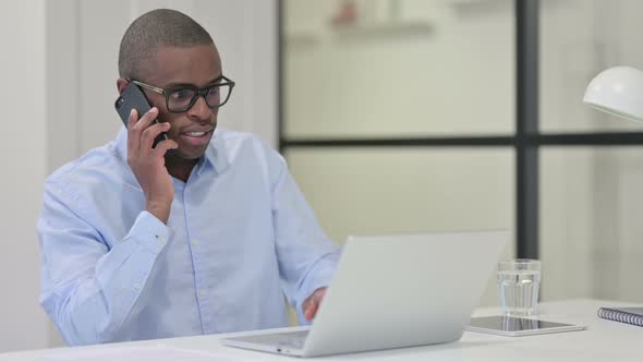 African Man Talking Phone Work alt