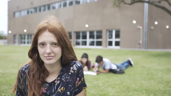 Teenage girl sitting in college campus