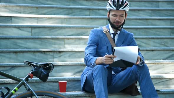 Hipster Businessman With Bicycle Sitting On Stairs