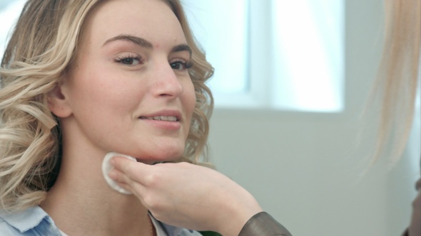 Make-Up Artist Cleaning Skin on Model Face