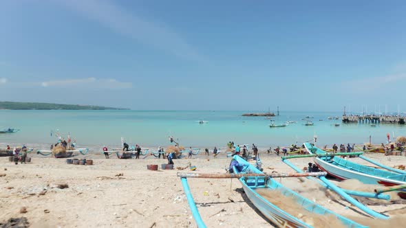 Fishermen in Colorful Traditional Boats on Sandy Beach in Bali Indonesia alt
