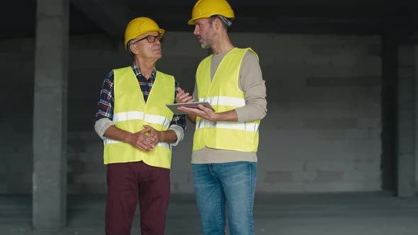 Two caucasian engineers on construction site. Shot with RED helium camera in 8K alt