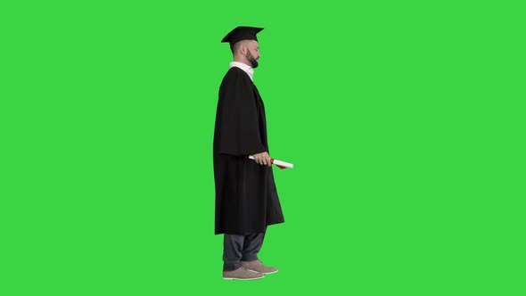 Happy and Excited Graduate Student Walking on a Green Screen, Chroma Key. alt