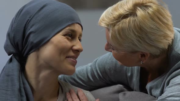 Mother Kissing Loving Daughter With Cancer Supporting During Chemotherapy alt