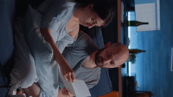 Vertical Video Confused Desperate Young Couple Reading Eviction Notice in Paperwork Letter alt