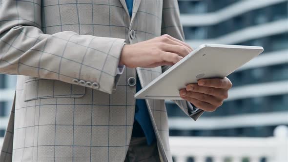 Stock Trader  Using Digital Tablet On Modern