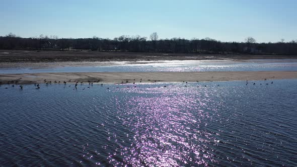 ‎⁨A low angle view over Rancocas Creek in NJ on a bright & sunny day. The drone camera dolly in then alt