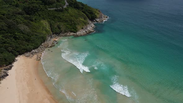 Aerial view of white sand beach and ocean wave alt