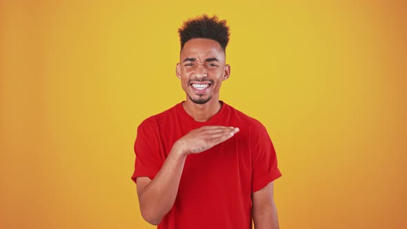 Young Black Guy Grimacing and Shaking Head and Hand No Rejection Concept Orange Studio Background alt