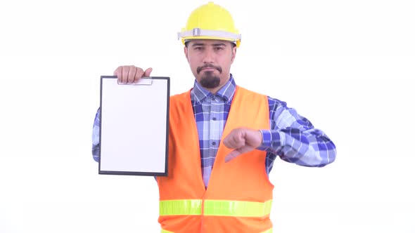 Stressed Bearded Persian Man Construction Worker Showing Clipboard and Giving Thumbs Down alt
