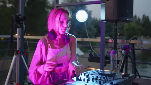 Cool Dj is Working in a Nightclub Standing at Turntables Creating a Dance Music Set Nightlife alt