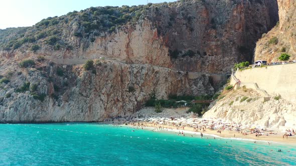 Aerial drone flying low near the turquoise blue Mediterranean Sea. During a sunset afternoon at Kapu alt