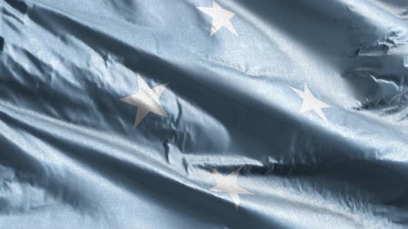 Federated States of Micronesia textile flag waving on the wind. Slow motion. 20 seconds loop.  alt