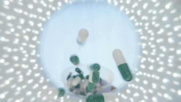 Colorful Capsules Of The Medication Is Falling Down Into The Camera