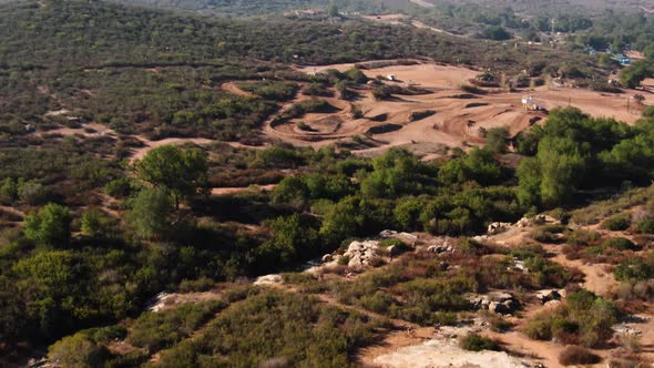 4K Drone Bikers Competing On Trail With Mountain Reveal alt