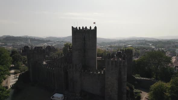 Cinematic aerial over Guimaraes Castle, Portugal, View Over City, Rising Reveal Shot
