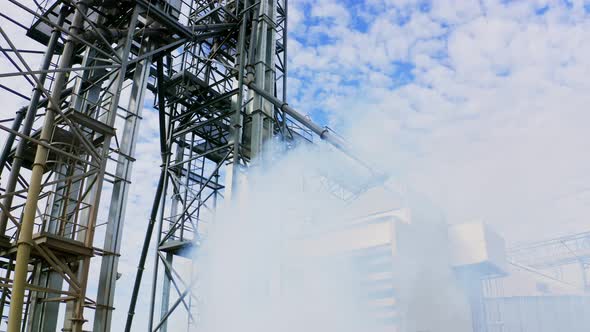 Plant construction of a large factory. Steel metal construction on blue sky background alt
