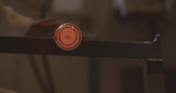 Professional glassblower working with glass at the workshop alt