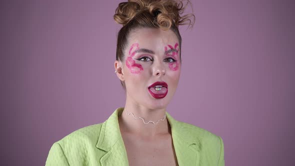 Young Beautiful Woman Professional Make Up Artist with Lipstick Marks Smile at Pink Background alt