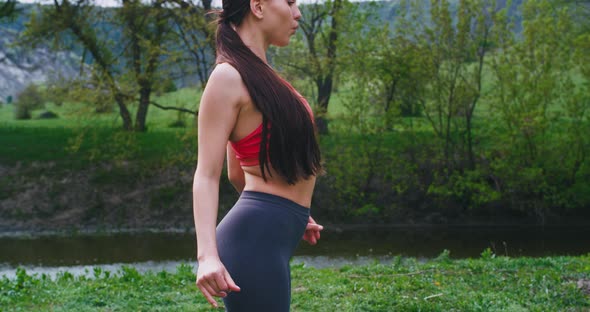 Attractive Woman in a Sportswear in the Middle of alt