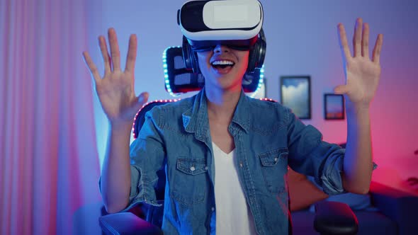 asia girl wear virtual reality glasses goggles headset feel surprise real game program in her neon. alt