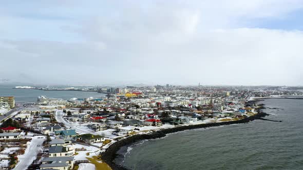 Drone aerial over the shoreline of the city of Reykjavik in Iceland alt